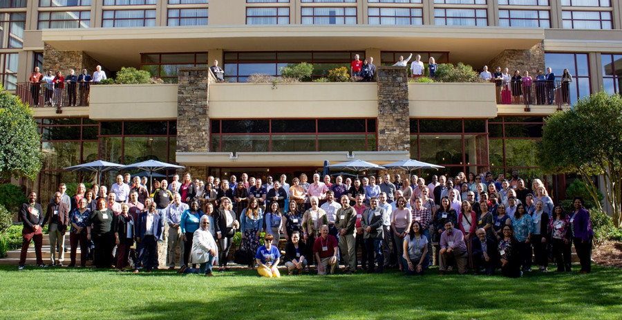 group of staff posing for a picture on the lawn