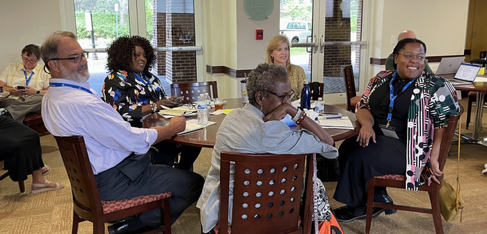 group of people at a table talking